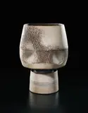 Pot with four indents and cylindrical foot by Hans Coper, circa 1975, Stoneware, layered white porcelain slips and engobes over a body with textured designs, the interior cylindrical stem-ho, sold Sep 2017