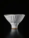 Oval bowl with fluted sides by Lucie Rie, circa 1980, Stoneware with fluted sides, white pitted glaze, sold Sep 2017