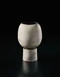 Pot on cylindrical foot by Hans Coper, circa 1974, Stoneware, layered white porcelain slips and engobes over a body with textured designs, the interior with manganese glaz, sold Sep 2017