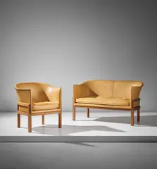 Mogens Koch, Two-seater sofa, model no. MK52, and armchair, model no. MK51, designed 1936, executed after 1951, Cuban mahogany, leather, leather-covered steel nailheads