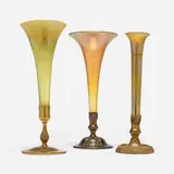 Collection of three trumpet vases with mounts by Tiffany Studios, c. 1920, hand-blown Favrile glass, acid-etched and patinated bronze, gilt bronze, sold Nov 2025