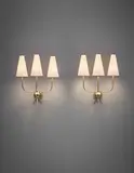 Jean Royere, Pair of 'Hirondelle' wall lights, 1950s, Tubular brass, brass, linen shades