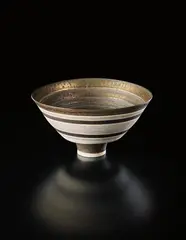 Lucie Rie, Conical bowl, 1976, Porcelain, golden manganese rim with bands of inlaid and sgraffito grid designs