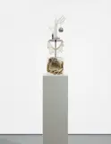 Josephine Meckseper, The Material for "U.S.A.", 2007, plexiglas cube, newspaper, metal stand, acrylic hand display, metal plaque, martini glass, mirrored ornament, necklace, wood plinth