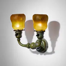 Two-arm sconce with pulled-feather shades by Tiffany Studios, c. 1910, hand-blown Favrile glass, patinated bronze, sold Nov 2025
