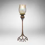 Root candlestick with shade by Tiffany Studios, c. 1905, patinated and acid-etched bronze, hand-blown Favrile glass, sold Nov 2025