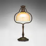 Damascene desk lamp by Tiffany Studios, c. 1910, hand-blown Favrile glass, patinated and acid-etched bronze, sold Nov 2025