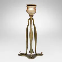 Candlestick with snuffer by Tiffany Studios, c. 1905, gilt bronze, gilt and acid-etched bronze, hand-blown Favrile glass, sold Nov 2025