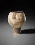 Footed pot by Hans Coper, circa 1956, Stoneware, the textured body with patches of red and manganese 'flag' designs, sold Oct 2015