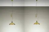 Pair of adjustable ceiling lights, model no. A 1965 by Paavo Tynell, 1950s, Perforated brass, brass, opaque glass, sold Oct 2015