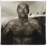 Tattooed man at a carnival, Md. by Diane Arbus, 1970, Gelatin silver print, printed later by Neil Selkirk, offered Nov 2014