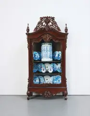 Wim Delvoye, Armoire, 1990, 22 Delft saw blades and 1 gas canister in wood and glass cabinet