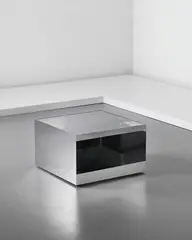 Joe D'Urso, Low rolling table, model no. 6027T, circa 1980, Mirror-polished stainless steel, safety glass
