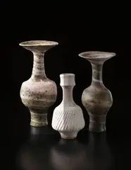Tall vase with flaring neck by Lucie Rie, circa 1980, Mixed clays thrown together producing an integral pink and green spiral in the heavily pitted glaze, sold Apr 2013