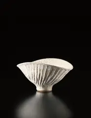 Large oval bowl with fluted design by Lucie Rie, circa 1975, Stoneware, cream pitted glaze with manganese speckle, sold Apr 2013