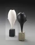 Hans Coper, 'Cycladic' winged bud form, circa 1976, Stoneware, layers of vitreous porcelain slip over a textured body painted with iron and manganese, the interior with a rich manganese glaze, black cuboid base