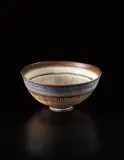 Bowl by Lucie Rie, circa 1962, Porcelain, manganese glaze with sgraffito bands, sold Apr 2013