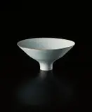 Footed bowl by Lucie Rie, circa 1966, Porcelain, light blue glaze with a manganese rim, sold Sep 2013