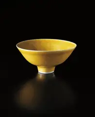 Footed bowl by Lucie Rie, circa 1972, Porcelain, mustard yellow glaze, sold Sep 2013
