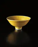 Footed bowl by Lucie Rie, circa 1972, Porcelain, mustard yellow glaze, sold Sep 2013