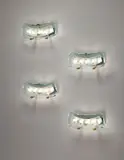 Max Ingrand, Set of four wall lights, model no. 1598, circa 1956, Clear glass, partially frosted glass and chiseled glass, brass