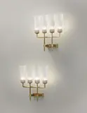 Paavo Tynell, Pair of wall lights, circa 1950, Gilded metal, opaque glass