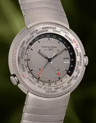 Iwc, A titanium “Reiseuhr” world time wristwatch with centre seconds, date, alarm, power reserve, bracelet and presentation box, 1998, Switzerland