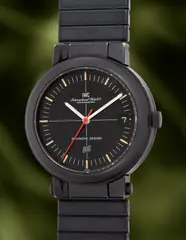 Iwc, An unusual and well-preserved black PVD-coated aluminium wristwatch with centre seconds, date, hinged case concealing a compass and an emergency beacon mirror and bracelet, 1979, Switzerland