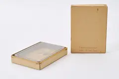 "Taschenzimmer" by Dieter Roth, 1972, Stempelaufdruck, Reißnagel und Bananenscheibe (verschimmelt) auf Papier in Kunststoffschachtel für ein Kartenspiel in Pa, sold Oct 2023