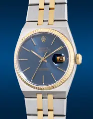 Rolex, A fine and "like-new" stainless steel and yellow gold quartz wristwatch with center seconds, date, blue dial and bracelet, Circa 1977