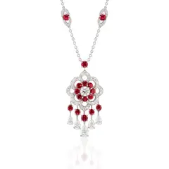 A Diamond and Ruby 'Rosette' Pendant Necklace by Anton Graff, - One brilliant-cut diamond, 0.70 carats - Five pear-shaped diamonds, 1.95 carats total - Twelve circular-cut rubies, 2., sold Sep 2021