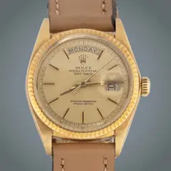 Rolex Day-Date 36, Untitled, Reference: 1803 <br> Movement: automatic, in-house mechanical movement: COSC-certified chronometer; central sweep seconds; instantaneous day and date change; hacking seconds <br> Functions: hours, minutes, central seconds, instantaneous day display at 12 o’clock, instantaneous date aperture at 3 o’clock with Cyclops magnifying lens. <br> Caliber/movement: 3055 <br> Power reserve: 48 h <br> Case: yellow gold <br> Case diameter: 36 mm <br> Bezel: yellow gold fluted bezel <br> Dial: gold applied baton indexes <br> Strap/bracelet: fitted with leather straps; with extra president bracelet in matching precious metal with concealed crownclasp folding clasp <br> No original box, no original papers <br> Weight: 69.7 grams <br> with aftermarket 18k Gold Strap (59.2 grams)