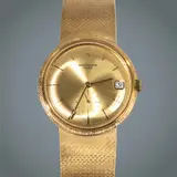 Patek Philippe Calatrava, Untitled, Reference: 3445/6 <br> Year: c. 1970s <br> Movement: Automatic, cal. 27-460 M <br> Functions: hours, minutes, central sweep seconds, date <br> Case: 18 karat yellow gold, round, three-piece case with snap-on case back, fluted case band, and signed crown <br> Case diameter: 35 mm <br> Thickness: 10.5 mm <br> Bezel: yellow gold <br> Dial: champagne, sunburst finish, applied yellow gold baton hour markers, faceted baton hands, central sweep seconds, outer minute track, date aperture at 3 o’clock <br> Strap/bracelet: Integrated yellow gold bracelet with concealed deployant clasp <br> Weight: 110 grams <br> With original box