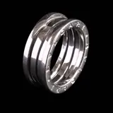 An 18k Thick Band Ring, Untitled, An 18k white gold band, designed in the distinctive style of the Bvlgari B.Zero1 collection. <br> Hallmarked 57, Made in Italy, 750, Italian assay marks <br> Signed Bvlgari <br> Weighs 9.80 grams.