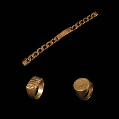 A Collection of Bracelet and Rings, Untitled, a.) A Curb-link ID Bracelet in 18k <br> The curb-link ID bracelet in 18k yellow gold features a central ID plate personalized with the engraving “Puno”. <br> The piece is accompanied by an extra link also in 18k. <br> Weighs 67.10 grams and 3.70 grams respectively. <br> <br> b.) A Monogram Ring in 18k <br> The 18k yellow gold ring features a JNP monogram in the center. <br> Weighs 20.90 grams. <br> <br> c.) A Signet Ring in 18k <br> The signet ring in 18k yellow gold features a coat of arms engraving in the center. <br> Hallmarked 750. <br> Weighs 15.60 grams.