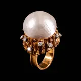 A Dramatic Pearl Cocktail Ring in 14k, Untitled, Designed in a free-form, naturalistic brutalist setting, a 20mm button pearl centers the ring in 14k yellow gold. It is accented by diamonds totaling approximately 0.60 cts. <br> Weighs 23.20 grams. <br> Diamonds noted as Pass on the GIA iD100®