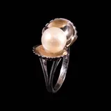 A Pearl Ring in 14k, Untitled, The 14k white gold ring designed as a clam pearl features an 8mm pearl in the center. <br> Weighs 4.10 grams.