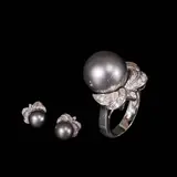Untitled by A Set of Gray Pearl and Diamond Jewelry in 14k, The set includes a matching ring and pair of earrings in 14k white gold. Each piece features a central gray pearl within, sold Jul 2026