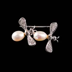 A Bee Pin in 14k, Untitled, A 14k white gold pin designed as two bees with 8mm drop-shaped pearls accented by diamonds weighing approximately 0.06 cts. <br> Weighs 4.20 grams. <br> Diamond noted as Pass on the GIA iD100®
