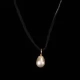 Untitled by A Golden South Sea Pearl Pendant in 18k, Suspended from a black cord necklace is a drop-shaped golden South Sea pearl pendant in 18k yellow gold. <br> Weighs 4.1, sold Jul 2026