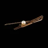 Untitled by A Pearl Tie Clip in 6k, A pearl tie clip in 6k yellow gold. <br> Weighs 2.10 grams., sold Jul 2026