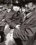 Man Holding Young Boy by Andy Warhol, 1982, Gelatin silver print, sold May 2017