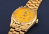 Rolex, An extremely rare and important yellow gold calendar wristwatch with centre seconds, bracelet and yellow lacquered “Stella” dial