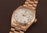 Rolex, An extremely rare and important pink gold wristwatch with Arabic calendar, applied pink gold Arabic numerals, bracelet, centre seconds and unusual tapisserie dial