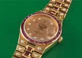 Rolex, A very rare and highly attractive yellow gold, diamond and ruby-set quartz calendar stone set bracelet watch with centre seconds and champagne dial