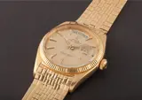 Rolex, A very rare and early yellow gold calendar wristwatch with unusual big logo bracelet, centre seconds and geometric engine turned dial