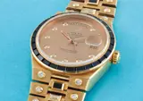 Rolex, A very rare and attractive yellow gold, diamond and sapphire-set calendar quartz stone set bracelet watch with centre seconds and champagne dial