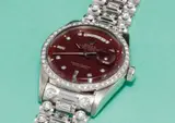 Rolex, A very rare, unusual and important white gold and diamond-set calendar wristwatch with centre seconds, bracelet and burgundy lacquered “Stella” dial