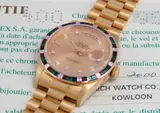 Rolex, A very rare and attractive yellow gold, diamond, ruby, emerald and sapphire-set calendar wristwatch watch with centre seconds, bracelet, champagne dial and original guarantee