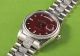 Rolex, A very rare and attractive white gold and diamond-set calendar wristwatch with centre seconds, bracelet and burgundy lacquered “stella” dial